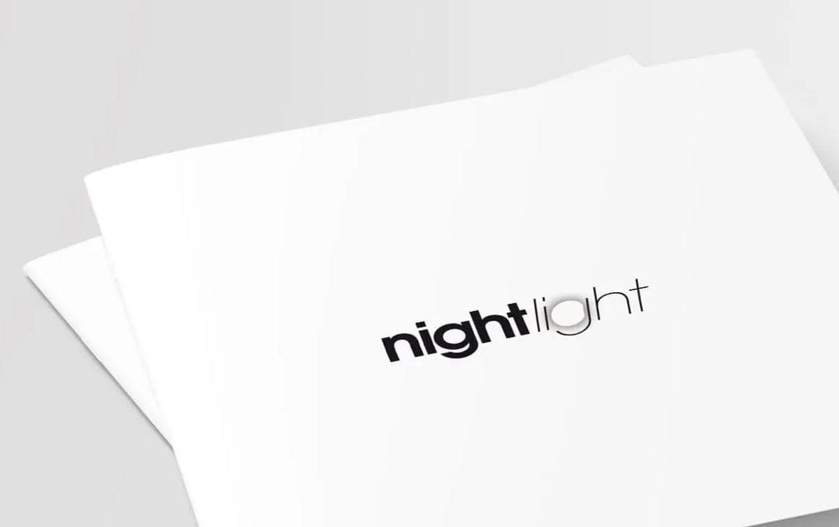 front cover beauty shot of night light catalogue depicting black logo on white paper